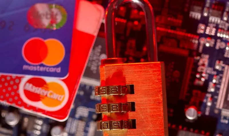 FILE PHOTO: Mastercard credit cards and a padlock on a computer motherboard